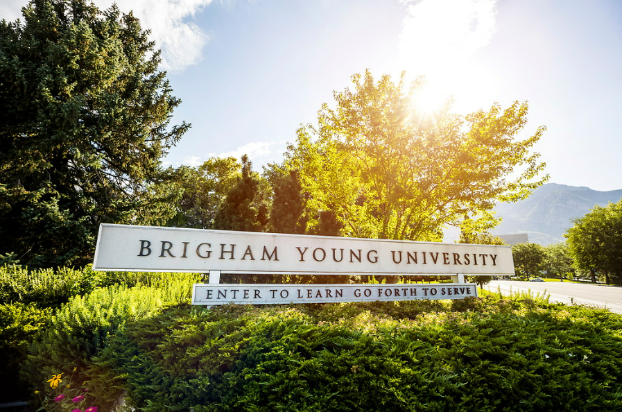 The Brigham Young University entrance sign with 'Enter to Learn, Go Forth to Serve' written beneath the name of the university.